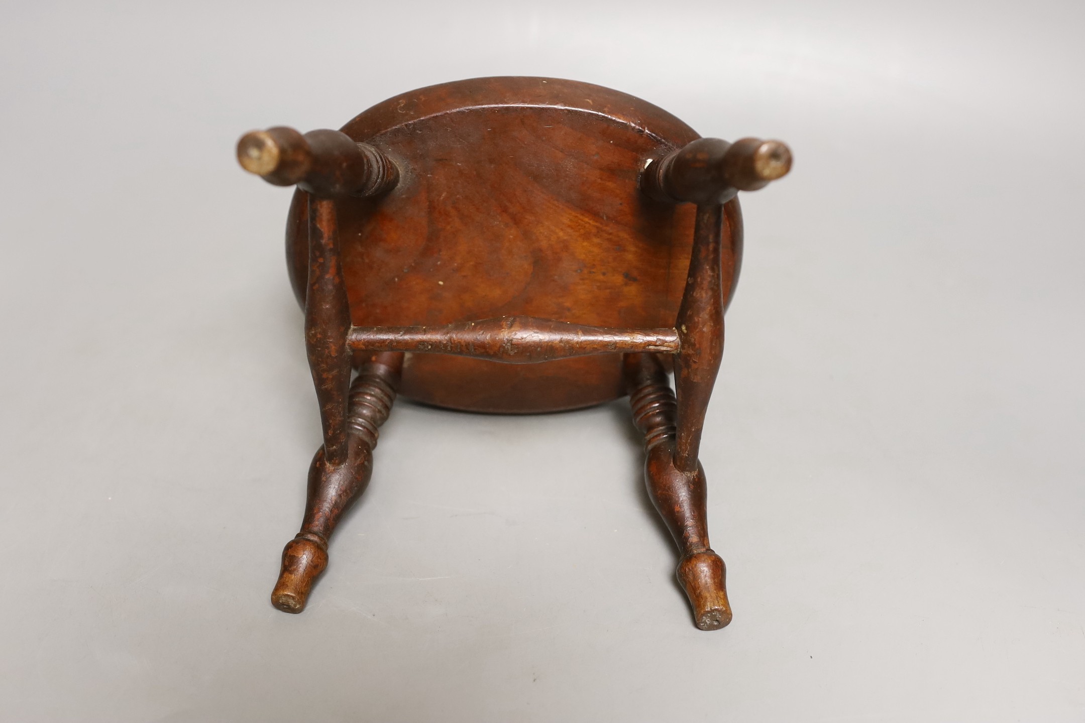 A 19th century walnut miniature stool, 12.5 cms high.